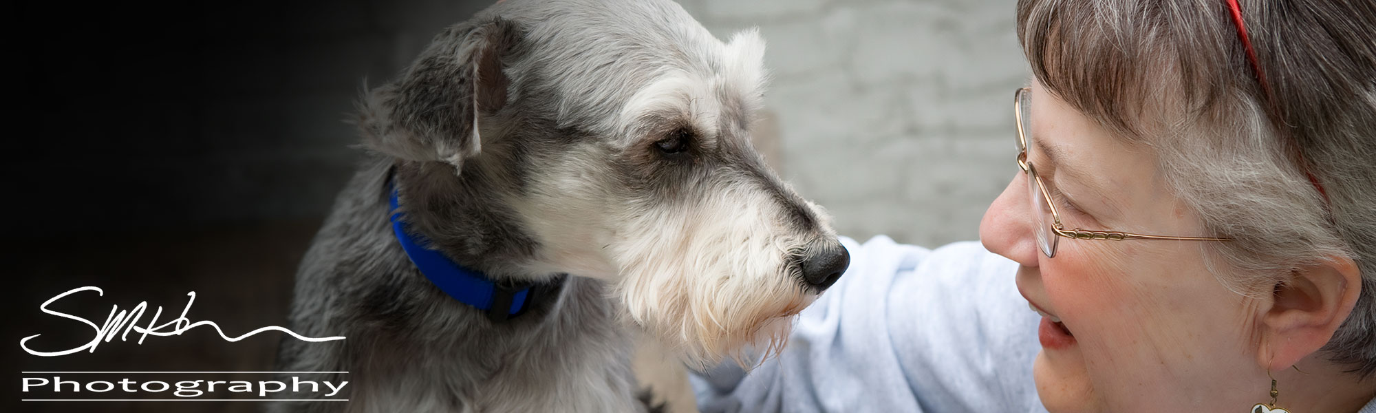 SMHerrick Photography supporting Dementia Society of America through photography: Image displayed - Aged woman smiling while looking into the eyes of her dog.